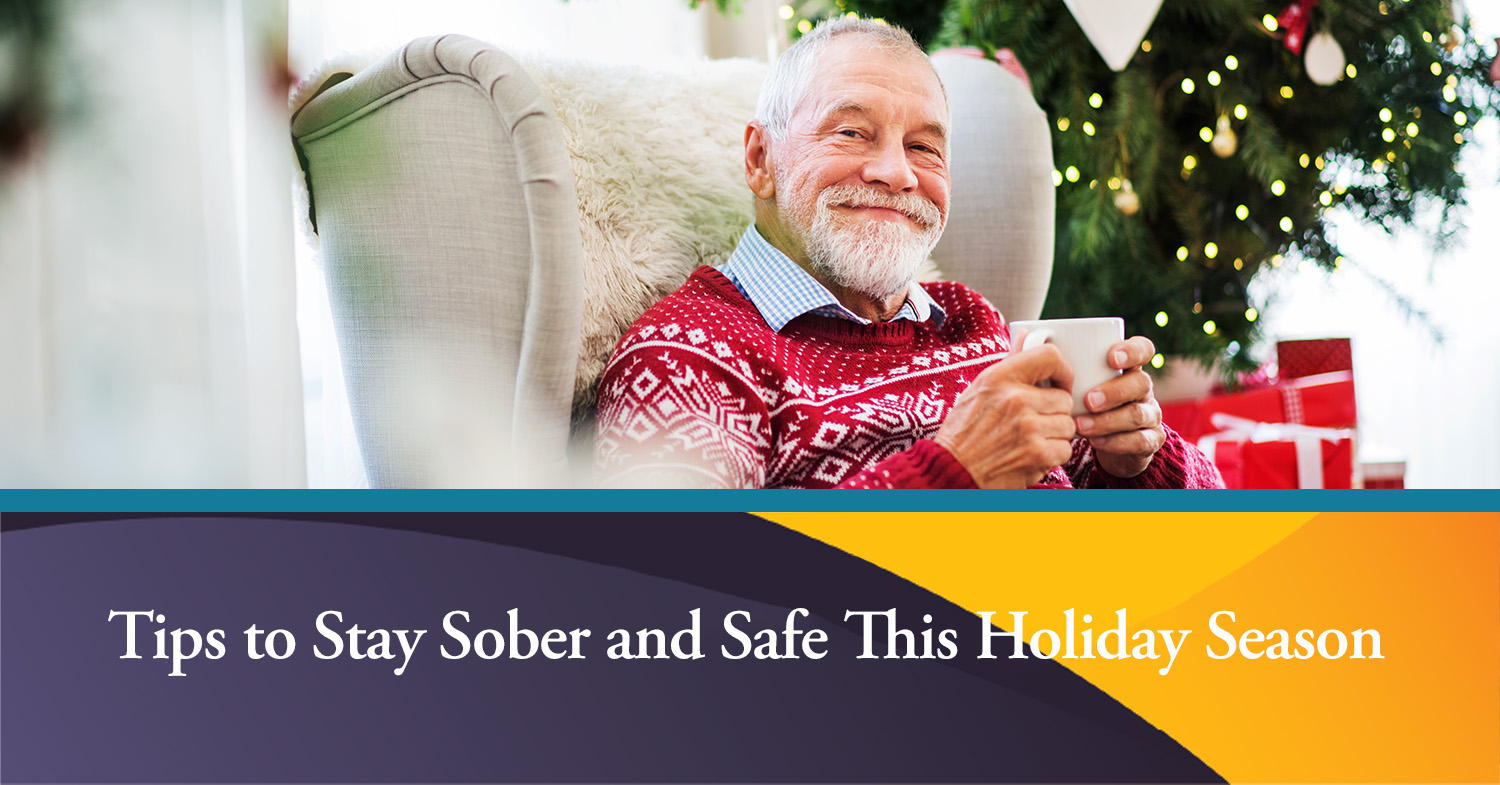 A man sitting in a chair in front of a Christmas tree, utilizing tips to stay sober this holiday season.